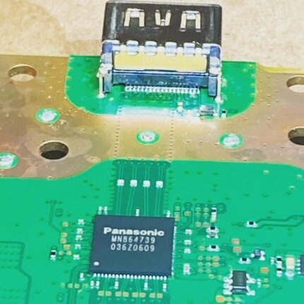 A Playstation 5 motherboard with a repaired HDMI port soldered into place