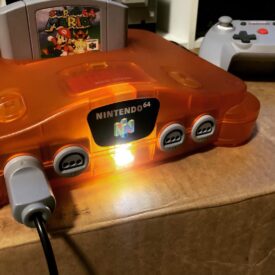 Orange Nintendo N64 Console with N64 HDMI Mod and playing Super Mario 64 Game