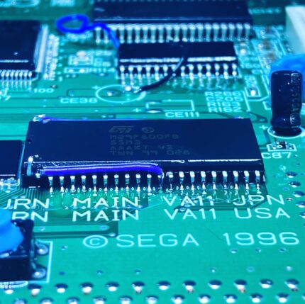 Close up of a Sega Saturn board with the soldered bios bios chip installed